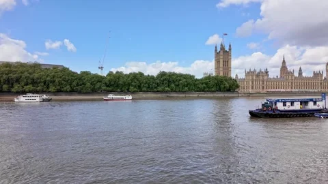Pan across the River Thames towards Big Ben and the Houses of Parliament Stock Footage 283291092