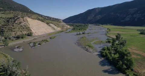 Pan across river in a valley 4k 24fps Stock Footage 77219044