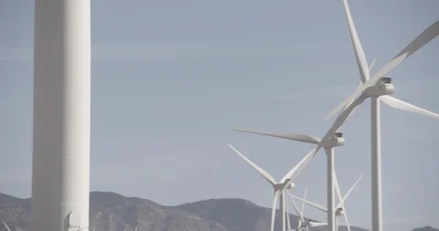 Pan Across Row of Wind Mills In Motion Stock Footage 89942437