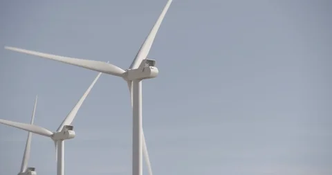 Pan Across Row of Wind Mills In Motion - Right to Left Stock Footage 89942446
