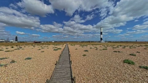Pan across the shingle beach in Dungeness on the Kent coast 스톡 동영상 281483419