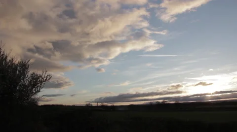 Pan across sky at sunset in a field Stock Footage 51734449