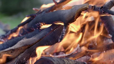 Pan across slow motion burning sticks in fire pit 4K Stock Footage 49908145