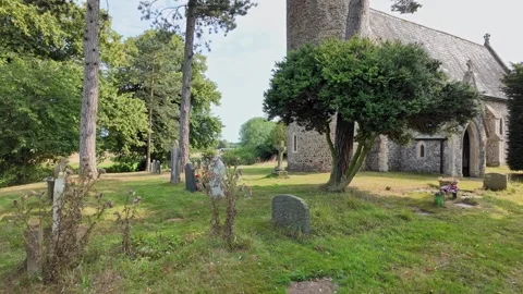 Pan across a small and abandoned church and churchyard in the countryside Stock Footage 283286641