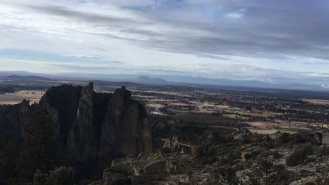 Pan across Smith Rock and snow covered mountains on horizon in Oregon Stock Footage 169667708