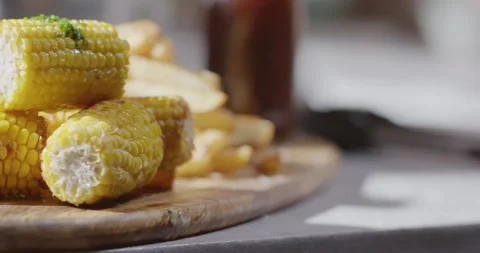 Pan Across Stack of Melted Herby Butter On Stack Of Sweet Corn On The Cob Video stock 161955113