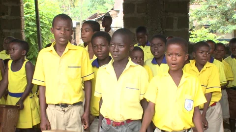 PAN ACROSS STUDENTS SINGING AT SCHOOL ASSEMBLY Stock Footage 60115517