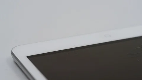 Pan across tablet computer with cracked screen Stock Footage 86779429