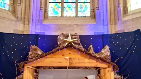 Pan up across traditional Catholic Nativity scene inside church in Nantes Stock Footage 340218751
