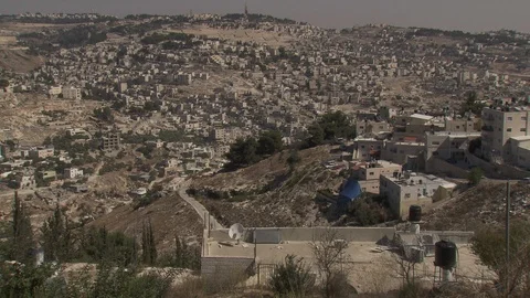 Pan across valley of homes and buildings in Jerusalem Stock Footage 86759658