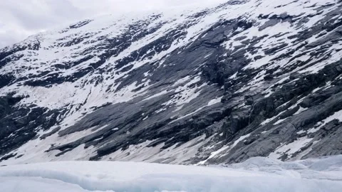 Pan across valley under Nigardsbreen glacier Stock Footage 230225700
