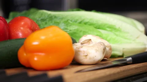 Pan across vegetables on cutting board Stock Footage 61406142