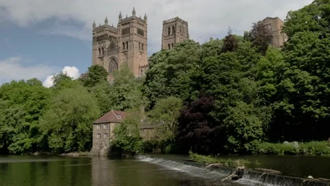Pan across weir in front of Durham Cathedra Stock Footage 205445646