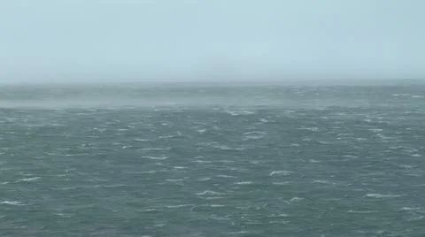 Pan Across Wind Blown Sea And Rocks Stock Footage 11440536