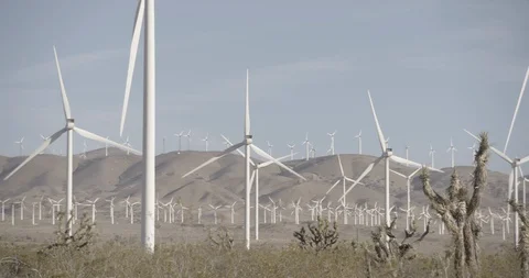 Pan Across Wind Mill Farm in Motion at California Foothills Stock Footage 89942402