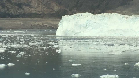 Pan along a glacier front and the icy ocean arctic Greenland Stock Footage 59998409
