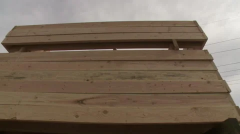 Pan along stacks of framing at a construction site Stock Footage 47377191