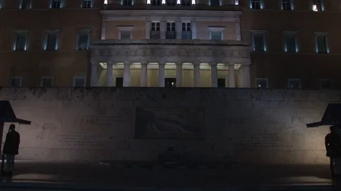 Pan up and down Night shot of Greek Parliament and Presidential guards Stock Footage 87621249