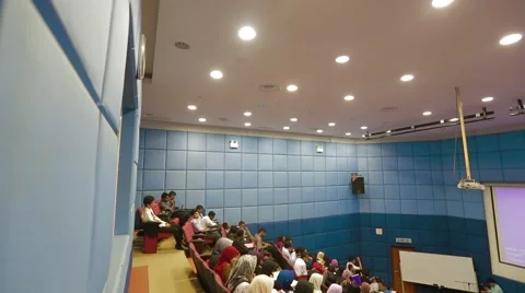 Pan and High Angle Shot of Students in Lecture Hall Taken From Behind Stock Footage 49388312