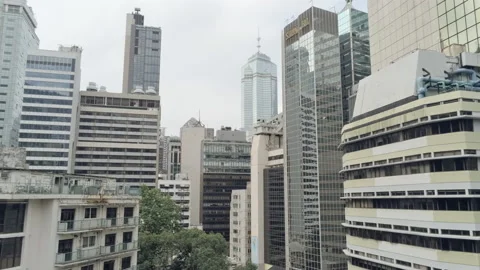 Pan and pedestal move down, descend. Drone shot close to high rise buildings  Video stock 172086457