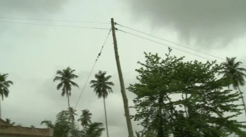 PAN AND TILT DOWN FROM ELECTRICITY POLES TO POLY TANK Stock Footage 60116174