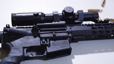 Pan of AR With Scope on Table From Barrel to Stock With Bullets Laying in 库存影片 119403847
