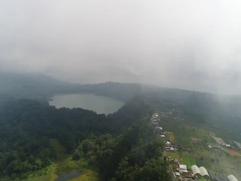 Pan around clouds, over small town and lake in Bali Indonesia. Stock Footage 80139498