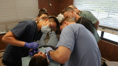 Pan Around Dentists Operating Stock-Footage 127001059