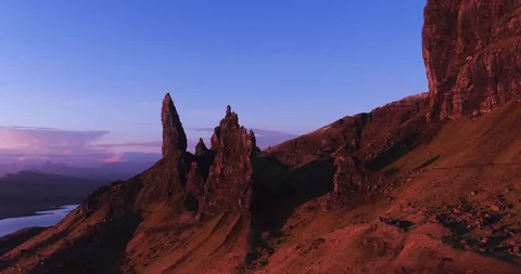 Pan around Old Man Storr at sunrise with beautiful colours drone aerial 4K Stock Footage 104581540
