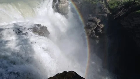 Pan from Athabasca Falls to Reveal Jasper’s Snow‑Tipped Mountain Above the Gorge Stock Footage 345007232