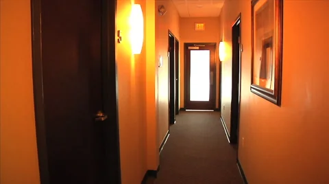 Pan back and forth of orange hallway, bed, lights, horror/calm 库存影片 45921195