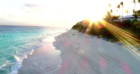 Pan back on Bermuda shore with sun flair Stock Footage 220540932
