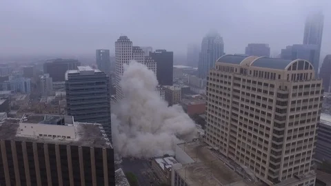Pan Back of Billowing Dust after Austin Building Implosion with Downtown in B Stock Footage 87668841
