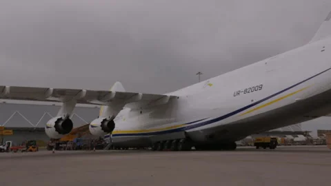 Pan backrudder tail to front from antonov heavy cargo airlift plane Stock Footage 248033946