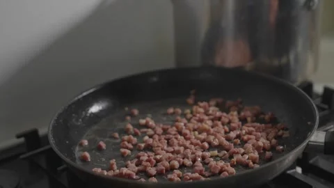 A pan of bacon is cooking on a stove Stock Footage 306042876