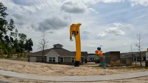 Pan of balloons and blow up prop for a new Apartment complex opening Horizon  Stock Footage 179954554