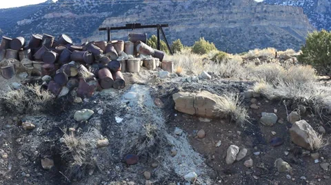 Pan of barrels dumped on the side of a hill. Stock Footage 35731223