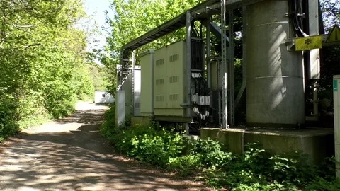 Pan: Base of a mobile tower. Technology, electricity, architecture and nature Stock Footage 76770660