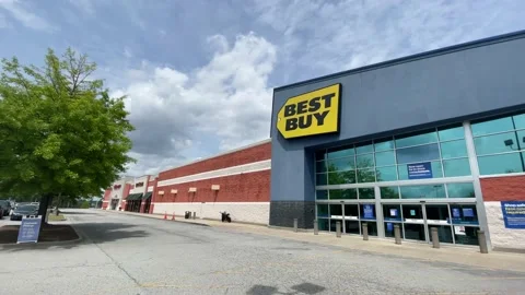 Pan of Best Buy retail store person walking out wearing face mask Stock Footage