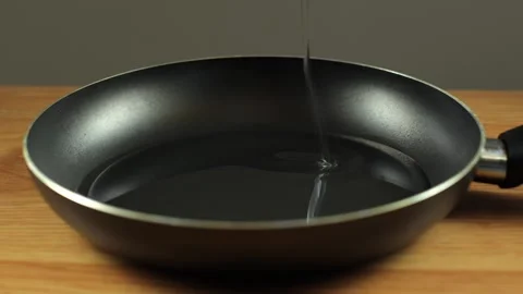 The pan is black on the table. A frying pan Stock Footage 273286904