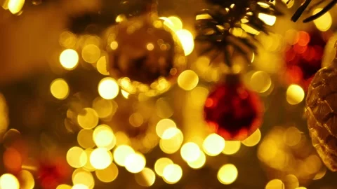 Pan: Blurry Christmas tree balls and lights with pine cone ornament in focus Stock Footage 146850802