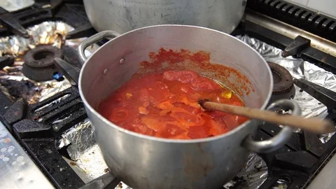 A pan of boiling tomato sauce in the professional kitchen in Italy, 4K Stock Footage 72302425