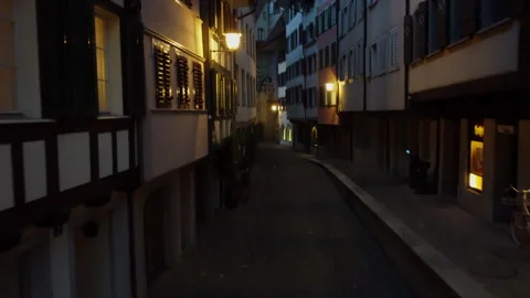 Pan from bottom to top while flying through the old town of Zug towards the Stock Footage 332429914
