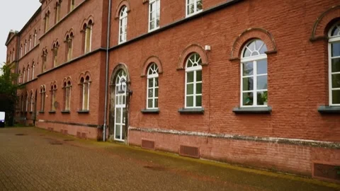 Pan up to a brick house wall with many floors and large white windows Stock Footage 255305087