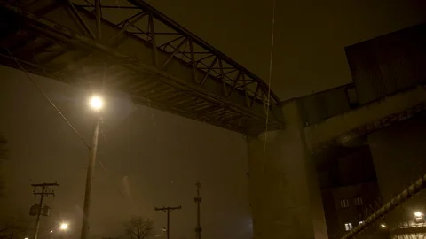 Pan to bridge with street light in background against night sky Stock Footage 89945467