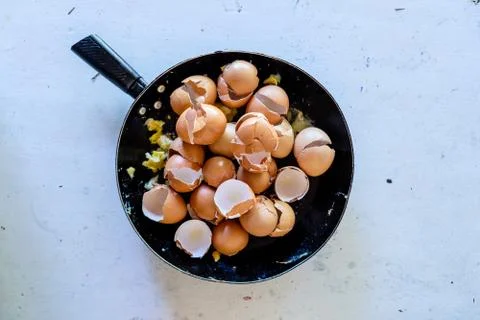 Pan with broken egg shells after cooking scrambled eggs with many eggs Stock Photos