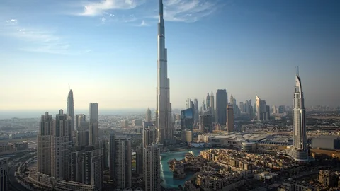 Pan up Burj Khalifa while tracking left over Downtown Dubai at 150m. Stock Footage 98941416