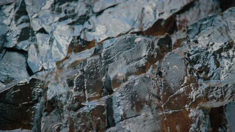 Pan Camera Close up Texture of Rock with Flowing Water Through Rock Nook Stock Footage 154017077