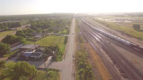 Pan from Car Driving Down Road To Train &amp;amp; Oil Storage Aerial Houston Stock Footage 61711731