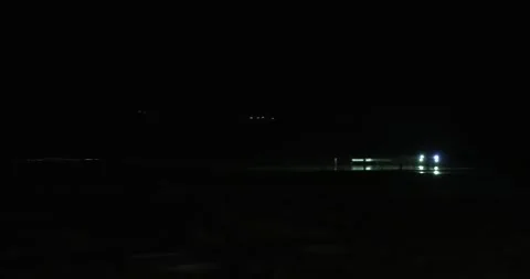 Pan with car headlights at night Stock Footage 277387486
